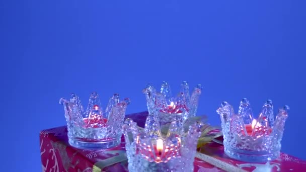 Blue Background New Year Candles Glass Stands Rotate Large Gift — Stock Video