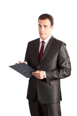 Successful businessman writing in clipboard