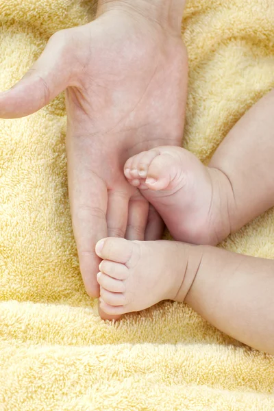 Baby's foot in father hands — Stock Photo, Image