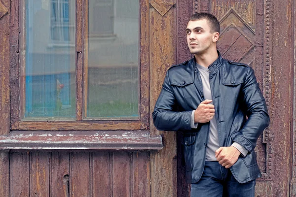 Brutal young man in a leather jacket — Stock Photo, Image