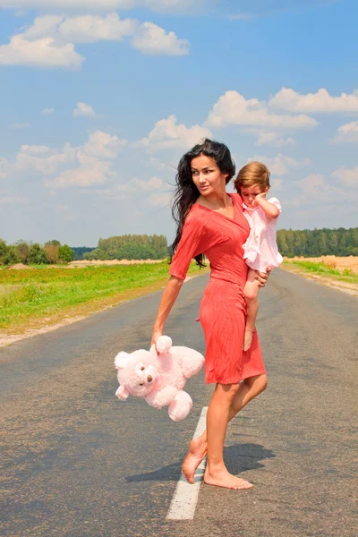 Beautiful woman holding her daughter — Stock Photo, Image