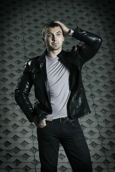 Brutal young man in a leather jacket — Stock Photo, Image