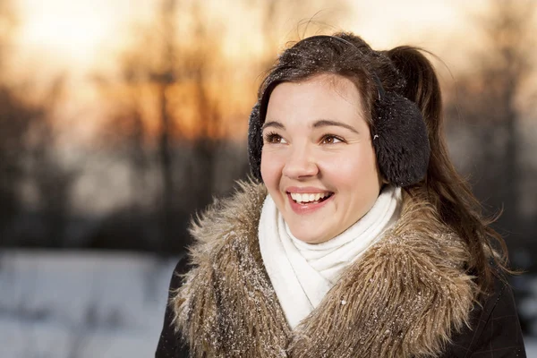 Beautiful girl with ear muffs — Stock Photo, Image