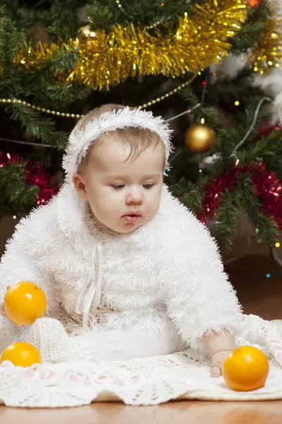 Glad liten baby flicka spelar med frukter — Stockfoto