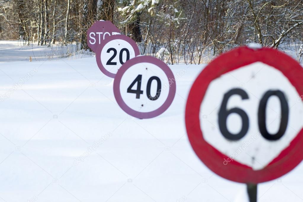 Speed limit signs under the snow