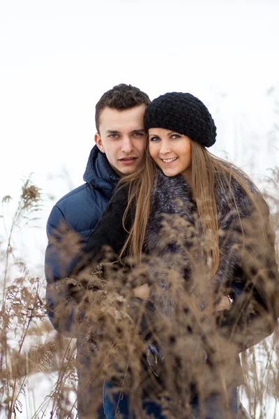 Jovem casal feliz no campo de inverno — Fotografia de Stock