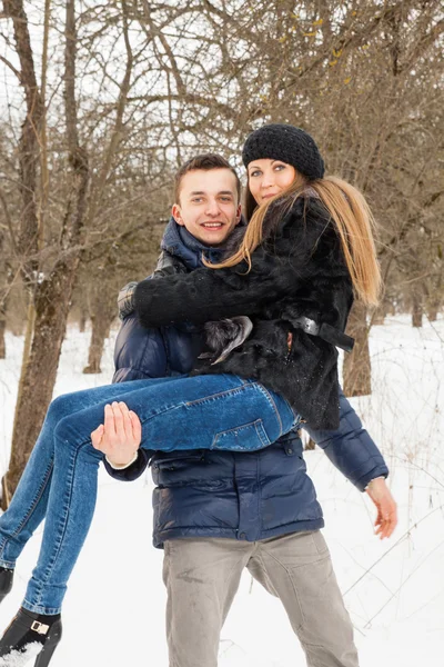 The young family plays winter wood on snow — 图库照片