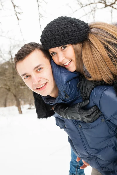 The young family plays winter wood on snow — 图库照片