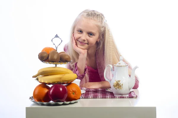 Little girl sitting at the table — Stock Photo, Image