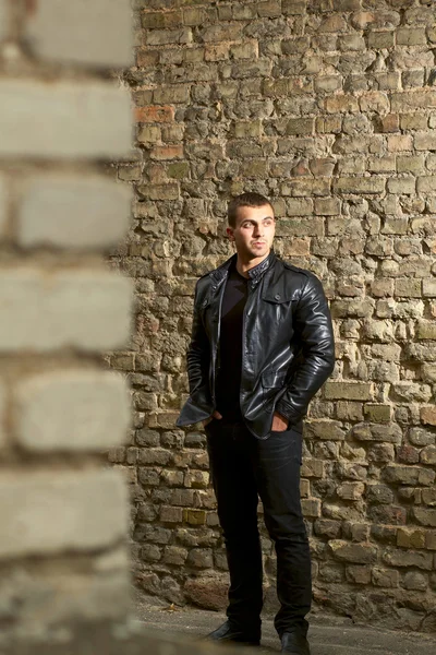 Brutal young sexual man in a leather jacket — Stock Photo, Image