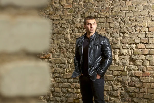 Brutal young sexual man in a leather jacket — Stock Photo, Image