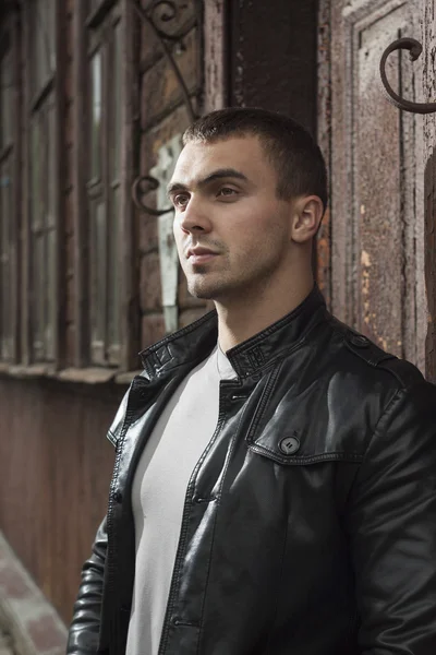 Brutal young man in a leather jacket — Stock Photo, Image