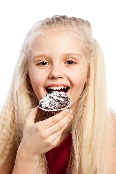 Menina mordendo um bolo de chocolate — Fotografia de Stock