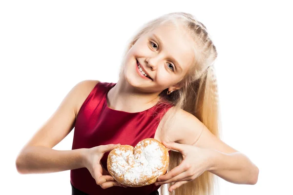 Girl holding a heart-shaped biscuit — Stock Photo, Image