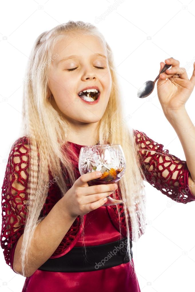 Beautiful blonde girl eating dessert