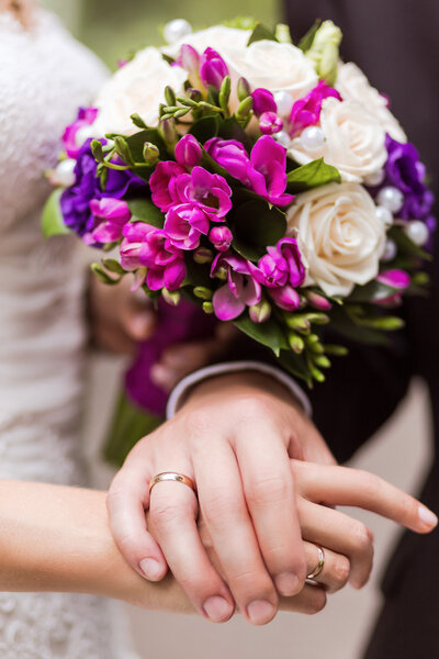 bride and groom holding hands