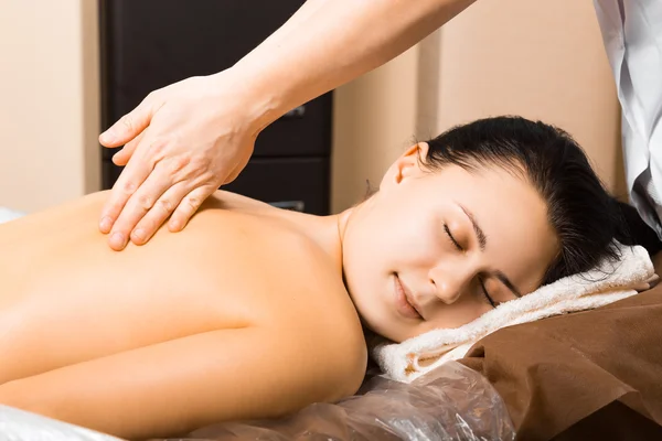 Beautiful young woman relaxing with hand massage — Stock Photo, Image