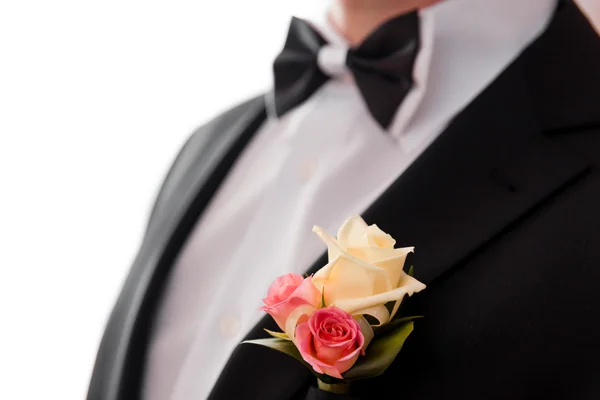 Boutonniere and bowtie close up. Royalty Free Stock Photos