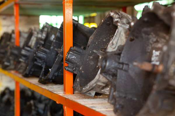 Used car parts on the store shelf. Used auto parts for sale in a store in a landfill. Transmissions for different kind of cars. Disassembly of cars.