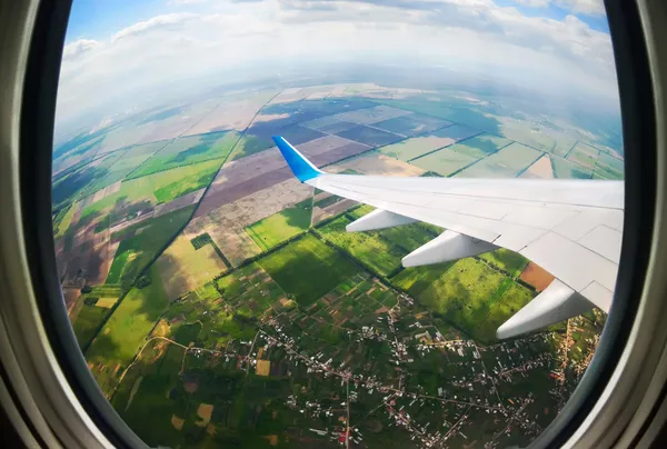 Blick durch das Bullauge eines Flugzeugs — Stockfoto