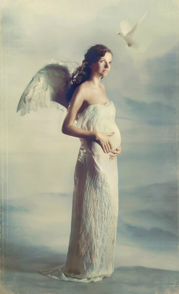 Beautiful young pregnant girl with angel wings with dove.