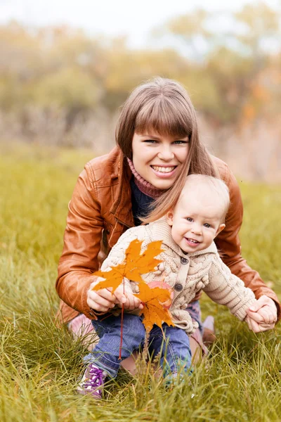 Happy family in autumn forest — Stock Photo, Image