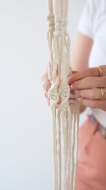 woman weaving macrame flower pot handmade indoors