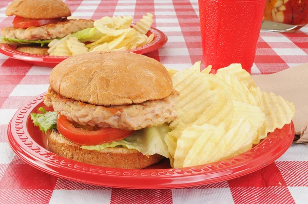 Turkey burgers on a picnic table — Stock Photo, Image