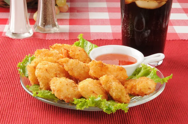 Coconut shrimp and a soft drink — Stock Photo, Image