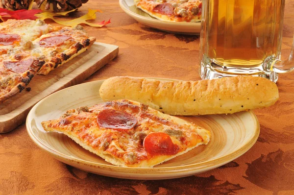 Pizza with beer and breadstiks — Stock Photo, Image