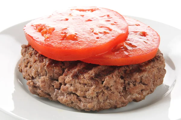 Hamburger patty with sliced tomato — Stock Photo, Image