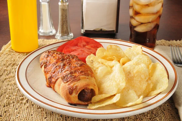 Pigs in a blanket with potato chips — Stock Photo, Image