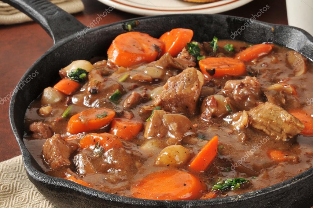 Gourmet beef stew served in a cast iron skillet Stock Photo by