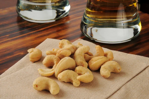 Bar snacks, cashwes and beer — Stock Photo, Image