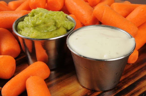 Fresh baby carrots with dips — Stock Photo, Image