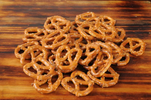 Salted pretzelson a wooden cutting board — Stock Photo, Image