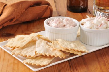 Flatbread crackers with dips and beer clipart