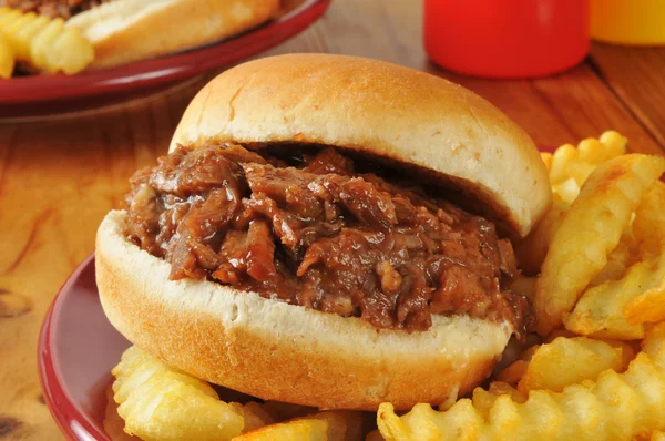 Barbecue beef sandwich and fries — Stock Photo, Image