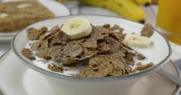 Rebanando Plátano Tazón Copos Salvado Orgánicos Con Leche — Vídeo de stock