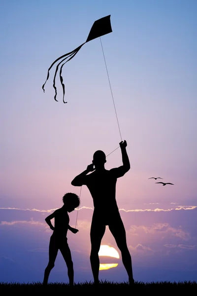 Отец и сын с воздушным змеем — стоковое фото