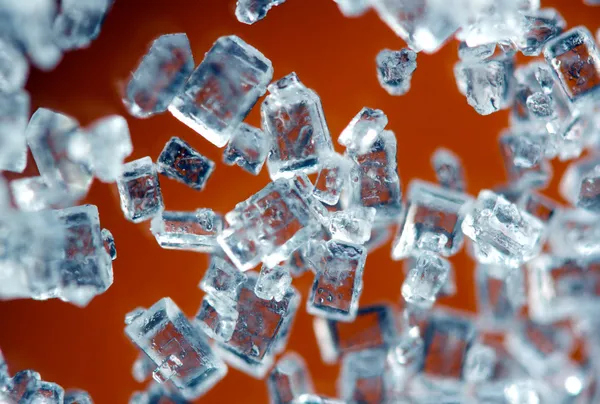 Crystals on a orange background. Extreme closeup. Macro Stock Picture