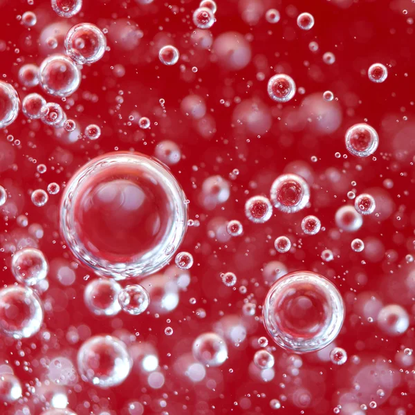 Burbujas de aire en un líquido. Fondo rojo abstracto. Macro —  Fotos de Stock