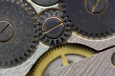 Metalik arka plan ile metal cogwheels bir saat gibi. Makro 