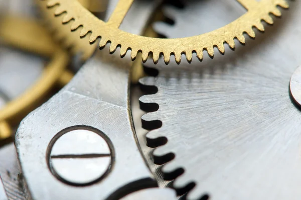 Achtergrond met metalen tandwielen een uurwerk. macro — Stockfoto