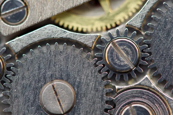 Arrière-plan avec roues dentées en métal une horloge. Macro, extrême clos — Photo