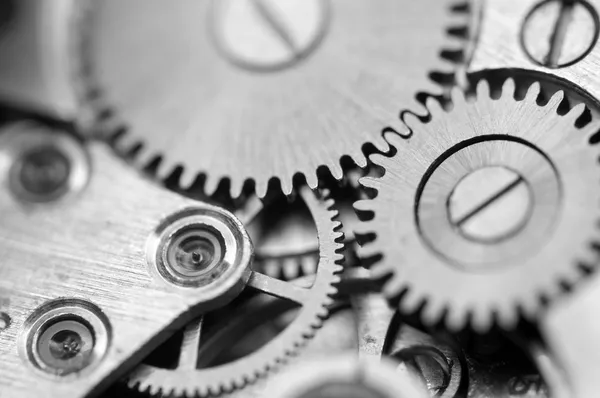 Fondo metálico blanco negro con ruedas dentadas de metal un reloj —  Fotos de Stock