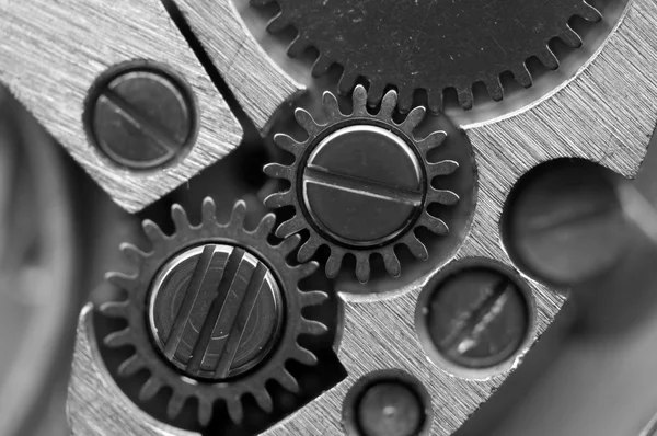 Fondo metálico blanco negro con ruedas dentadas de metal un reloj — Foto de Stock