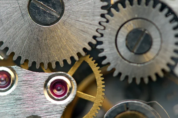 Fondo metálico con ruedas dentadas de metal un reloj. Macro — Foto de Stock