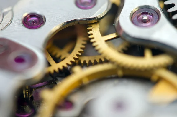 Fondo metálico con ruedas dentadas de metal un reloj. Macro — Foto de Stock