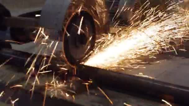 Cutting a metal pipe on the abrasive machine , sparkles fly out Video Clip